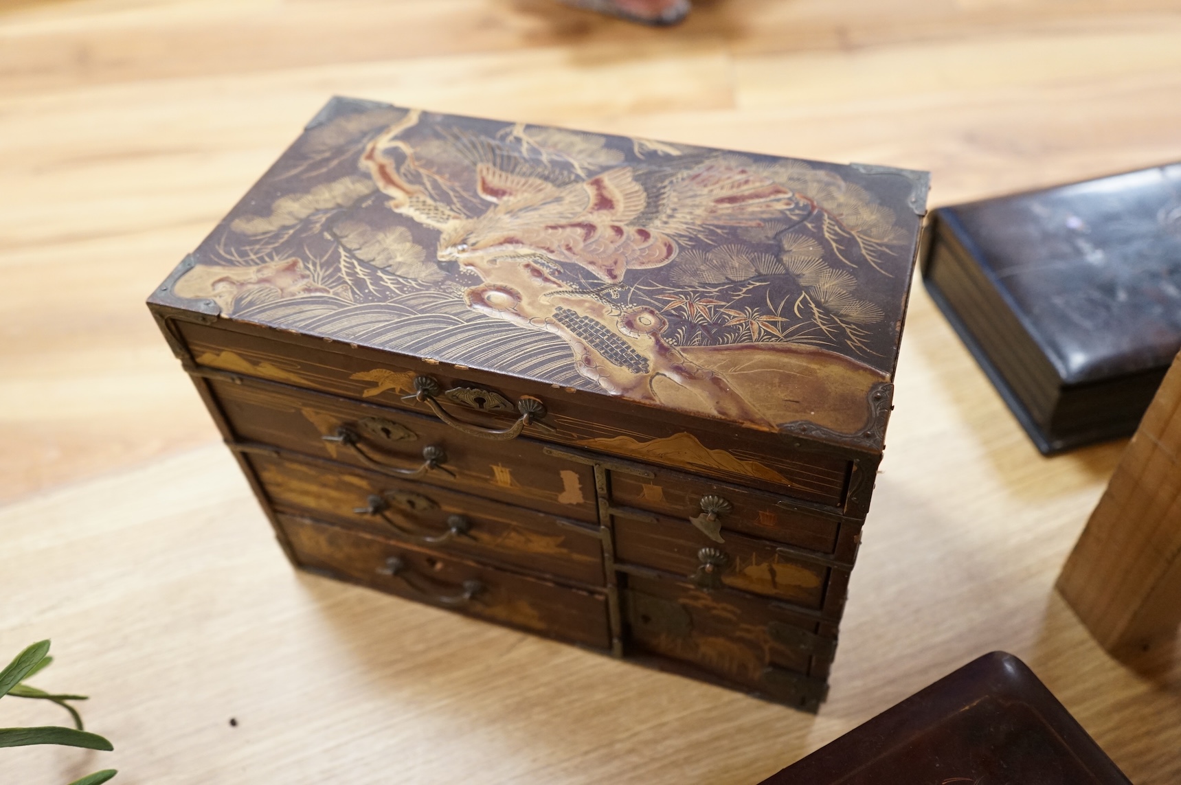 A group of 19th/20th century Japanese lacquer boxes and a similar tabletop cabinet, the latter 31cm wide